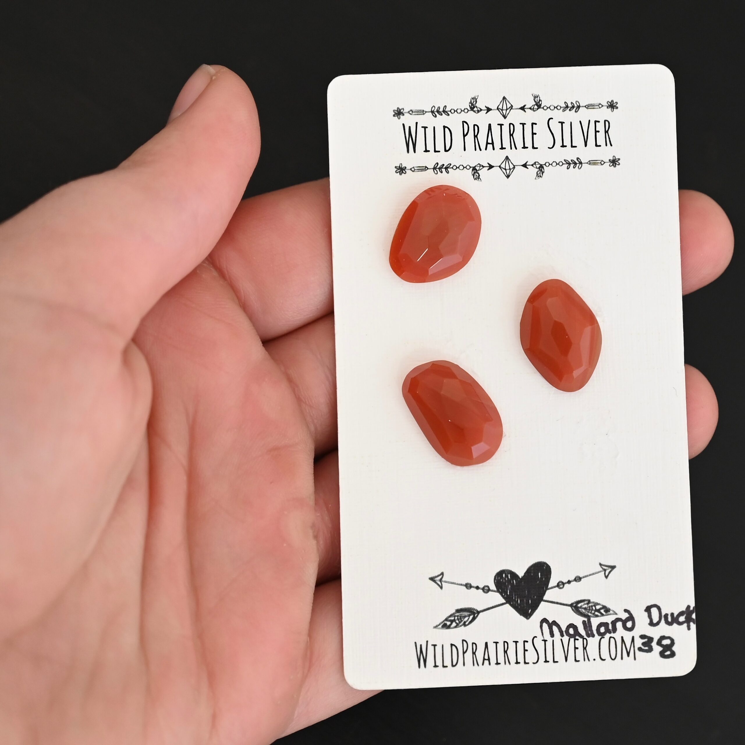 Mallard Duck Rose Cut Carnelian Cabochon Parcel shown in hand