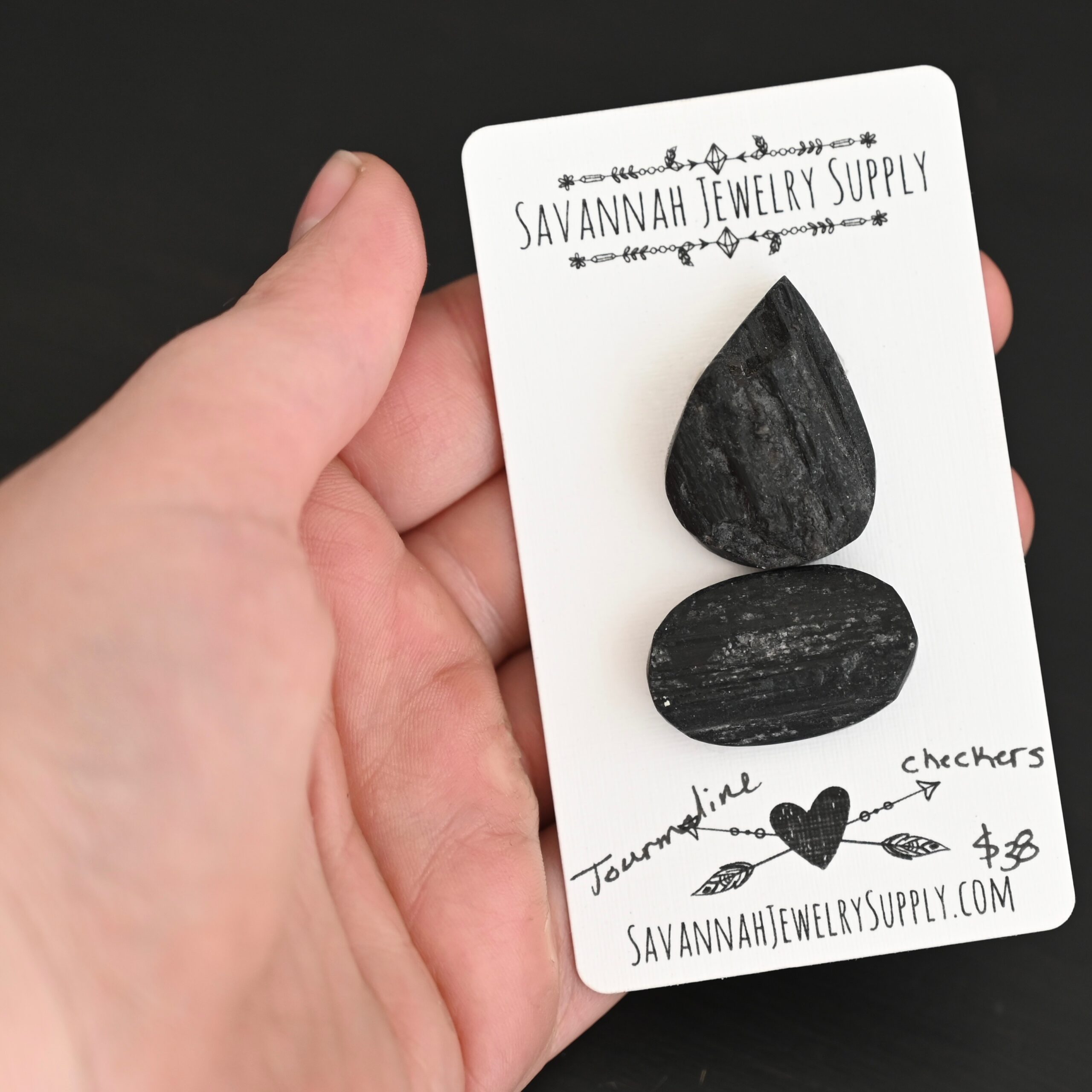 Checkers Tourmaline Cabochon Parcel shown in hand