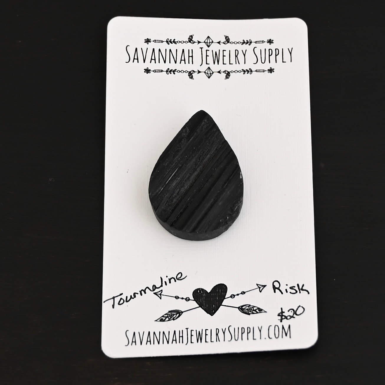 Risk Tourmaline Cabochon shown on business card