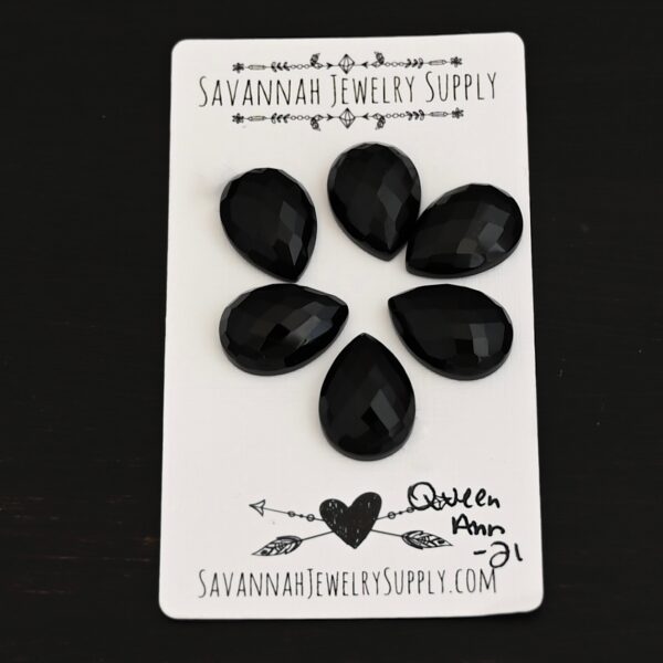 Queen Ann Rosecut Teardrop Black Onyx Cabochon Parcel shown on business card