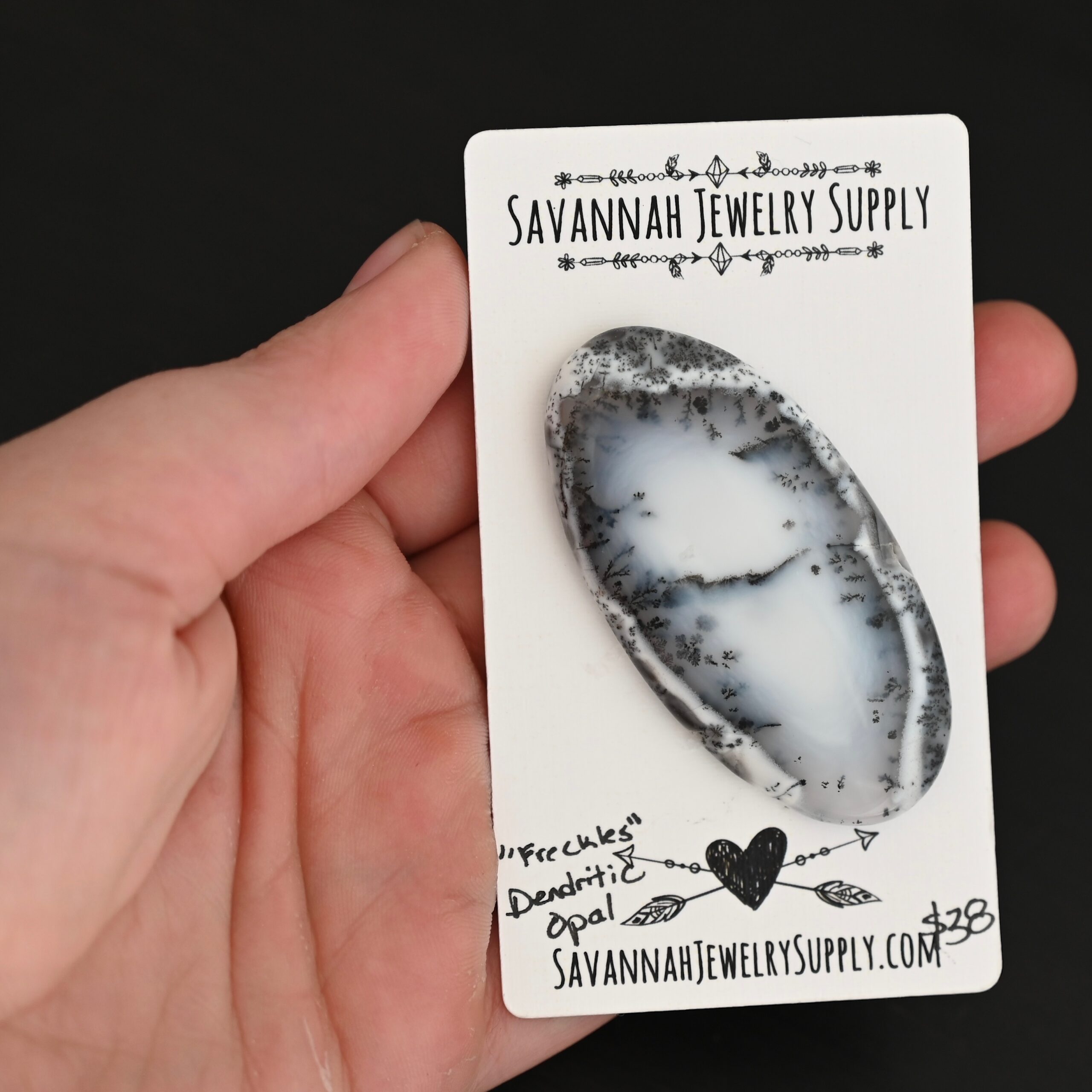 Freckles Dendritic Opal Cabochon shown in hand