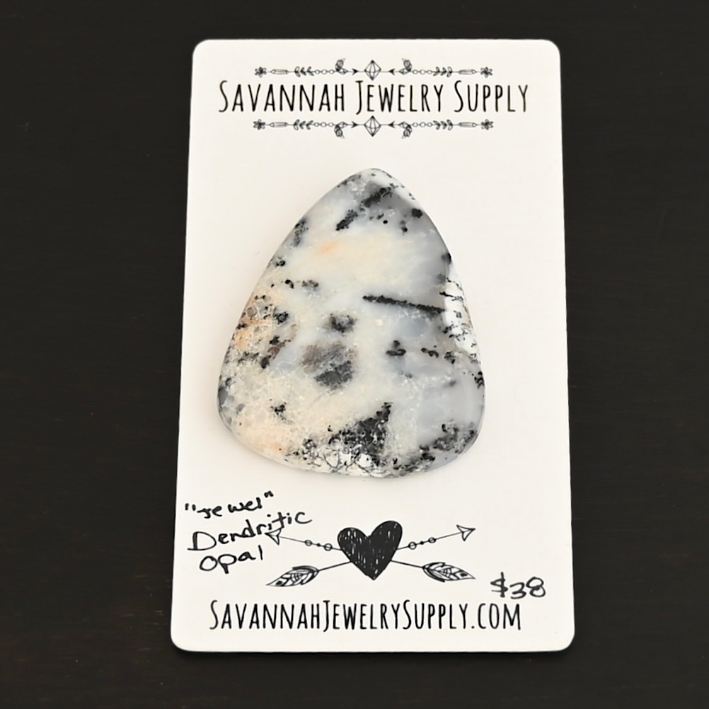 Jewel Dendritic Opal Cabochon shown on business card