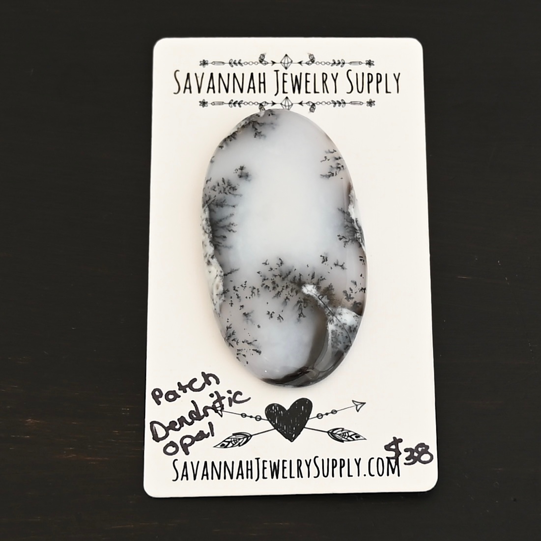 Patch Dendritic Opal Cabochon shown on business card