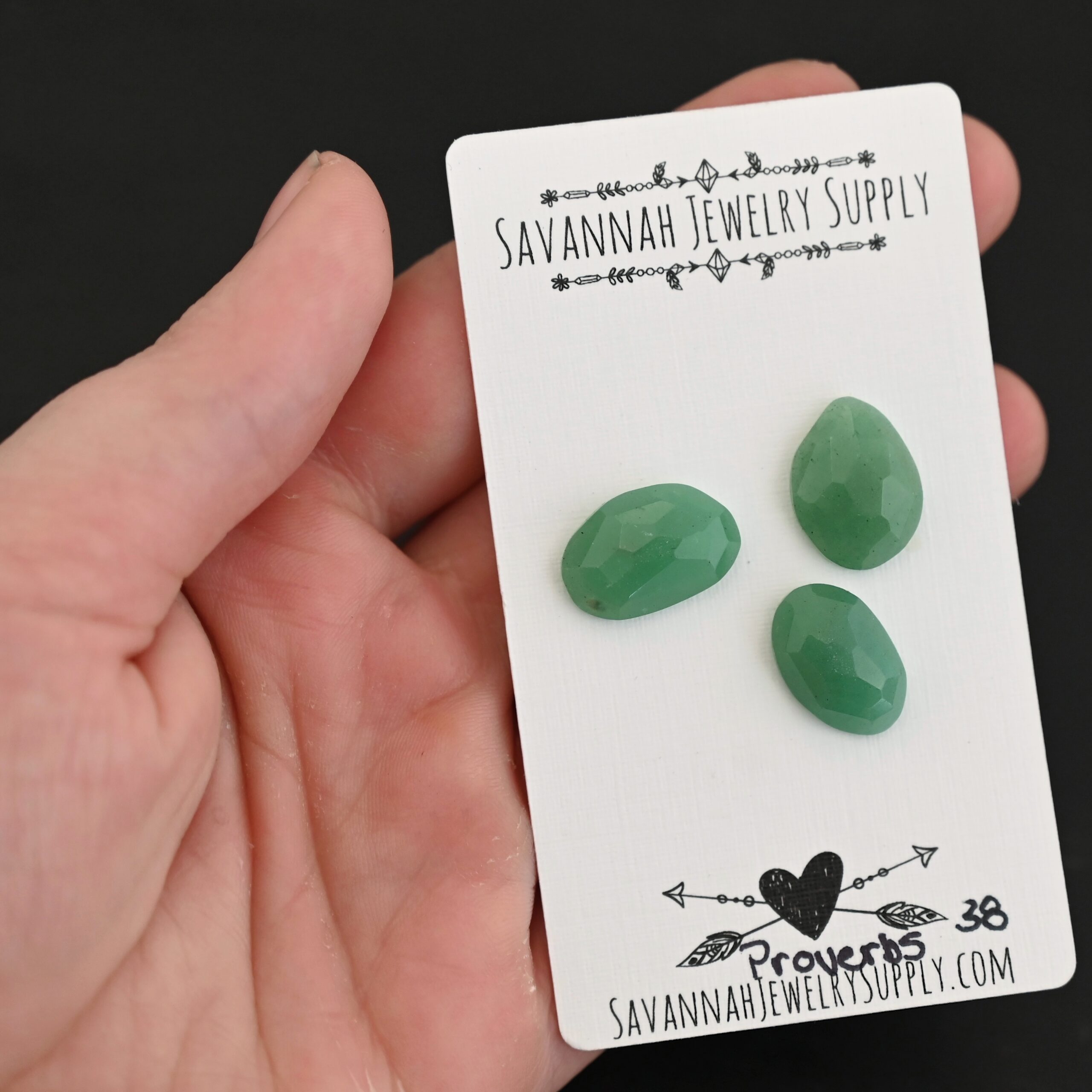 Proverbs Adventurine Cabochon Parcel shown in hand