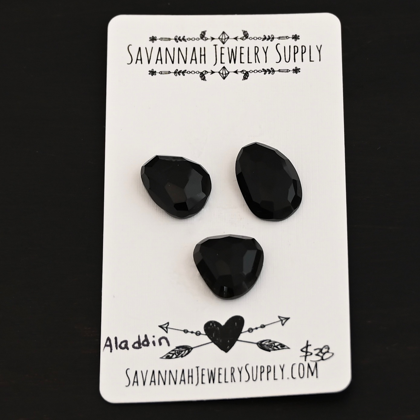 Aladdin Black Onyx Cabochon Parcel shown on business card