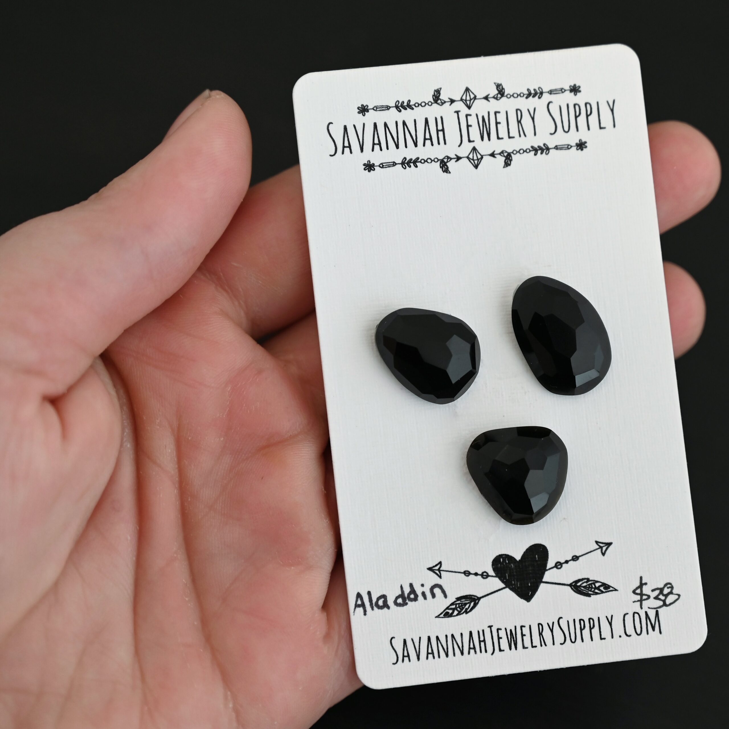 Aladdin Black Onyx Cabochon Parcel shown in hand