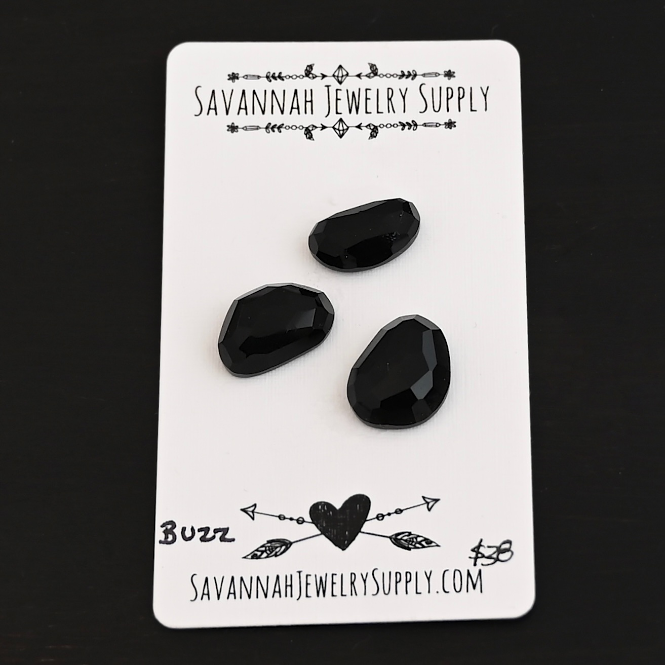 Buzz Black Onyx Cabochon Parcel shown on business card