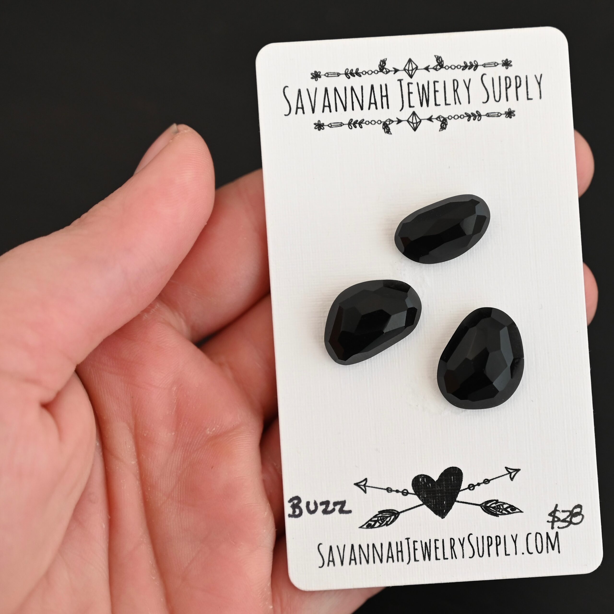 Buzz Black Onyx Cabochon Parcel shown in hand