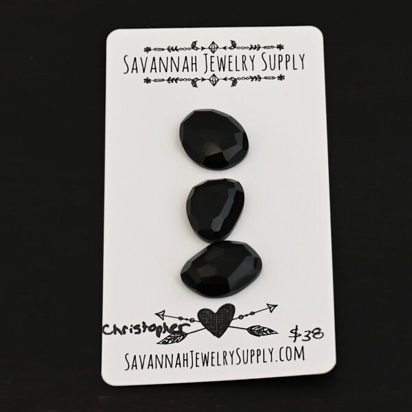 Christopher Black Onyx Cabochon Parcel shown on business card