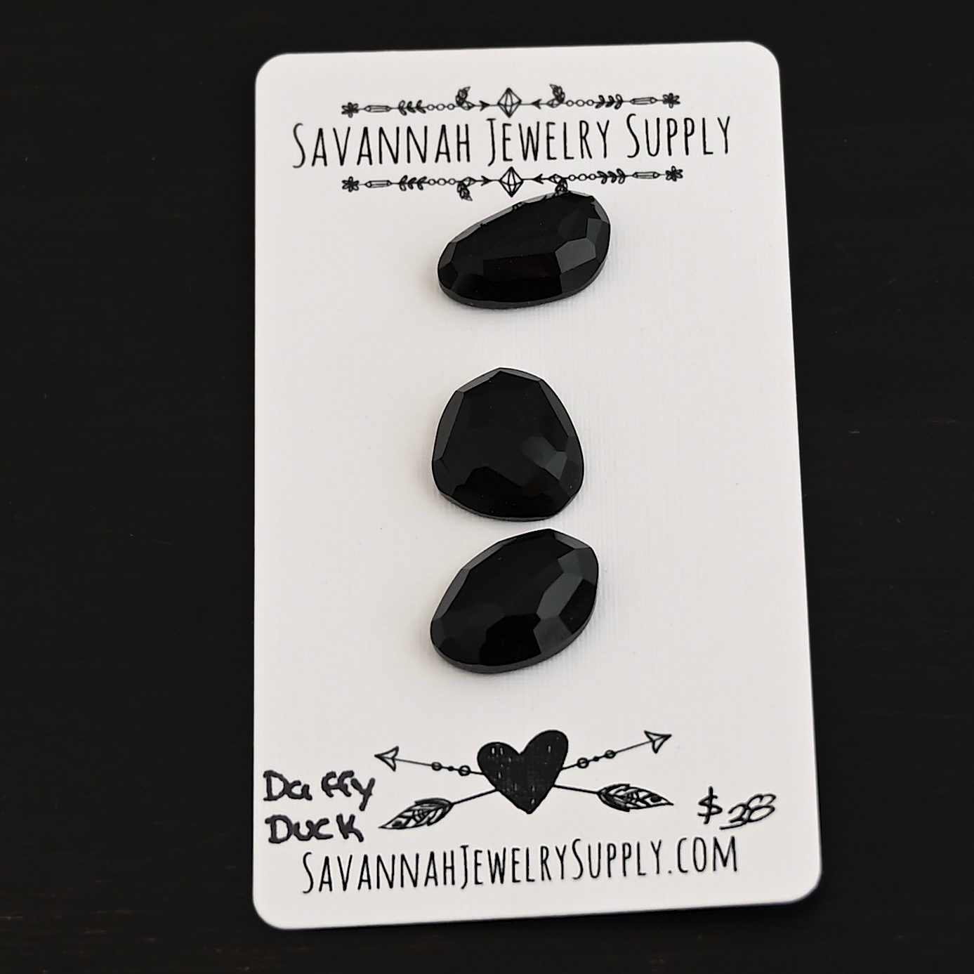 Daffy Duck Black Onyx Cabochon Parcel shown on business card