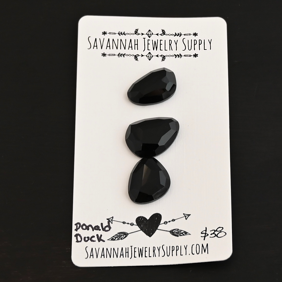 Donald Duck Black Onyx Cabochon Parcel shown on business card