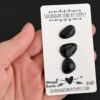Donald Duck Black Onyx Cabochon Parcel shown in hand
