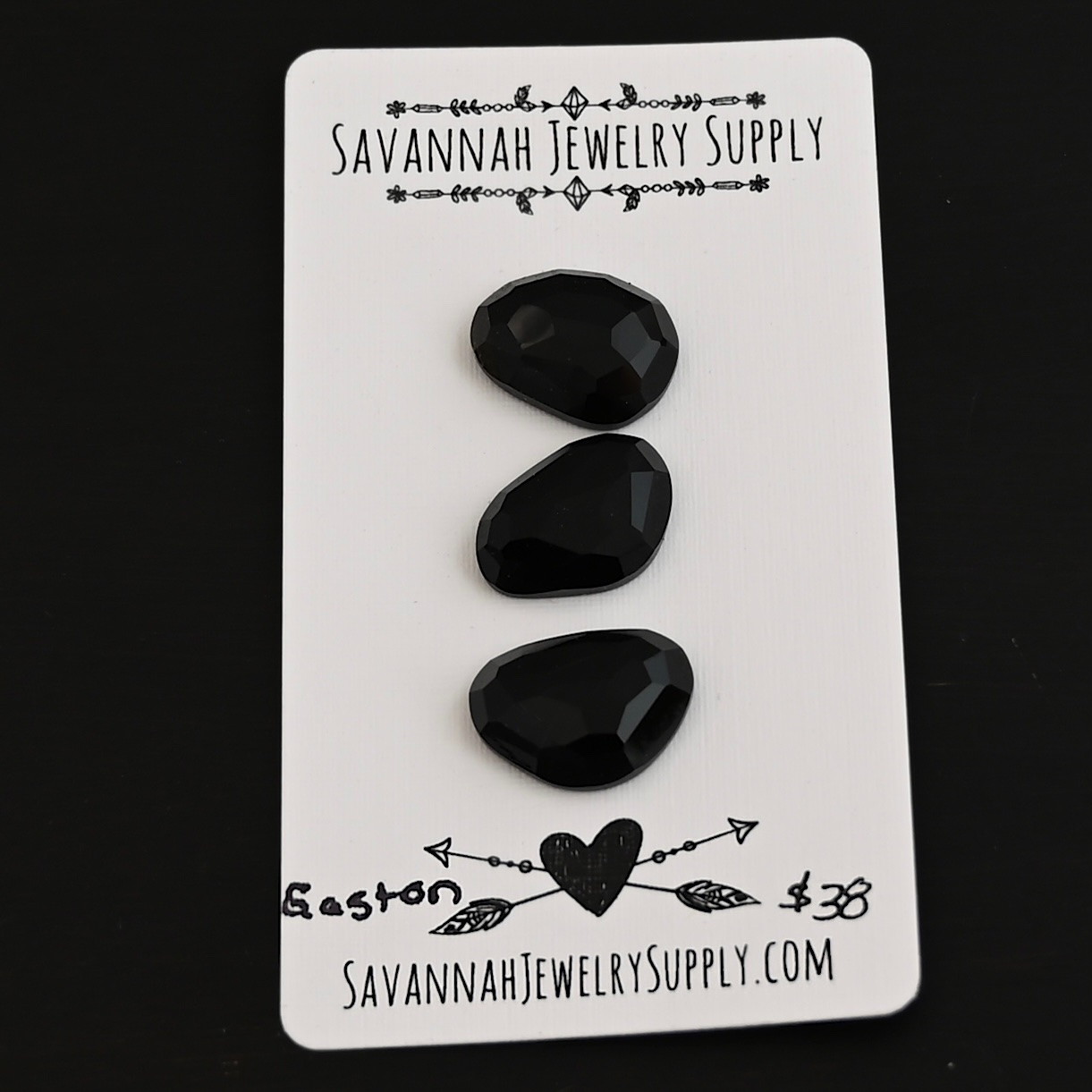 Gaston Black Onyx Cabochon Parcel shown on business card