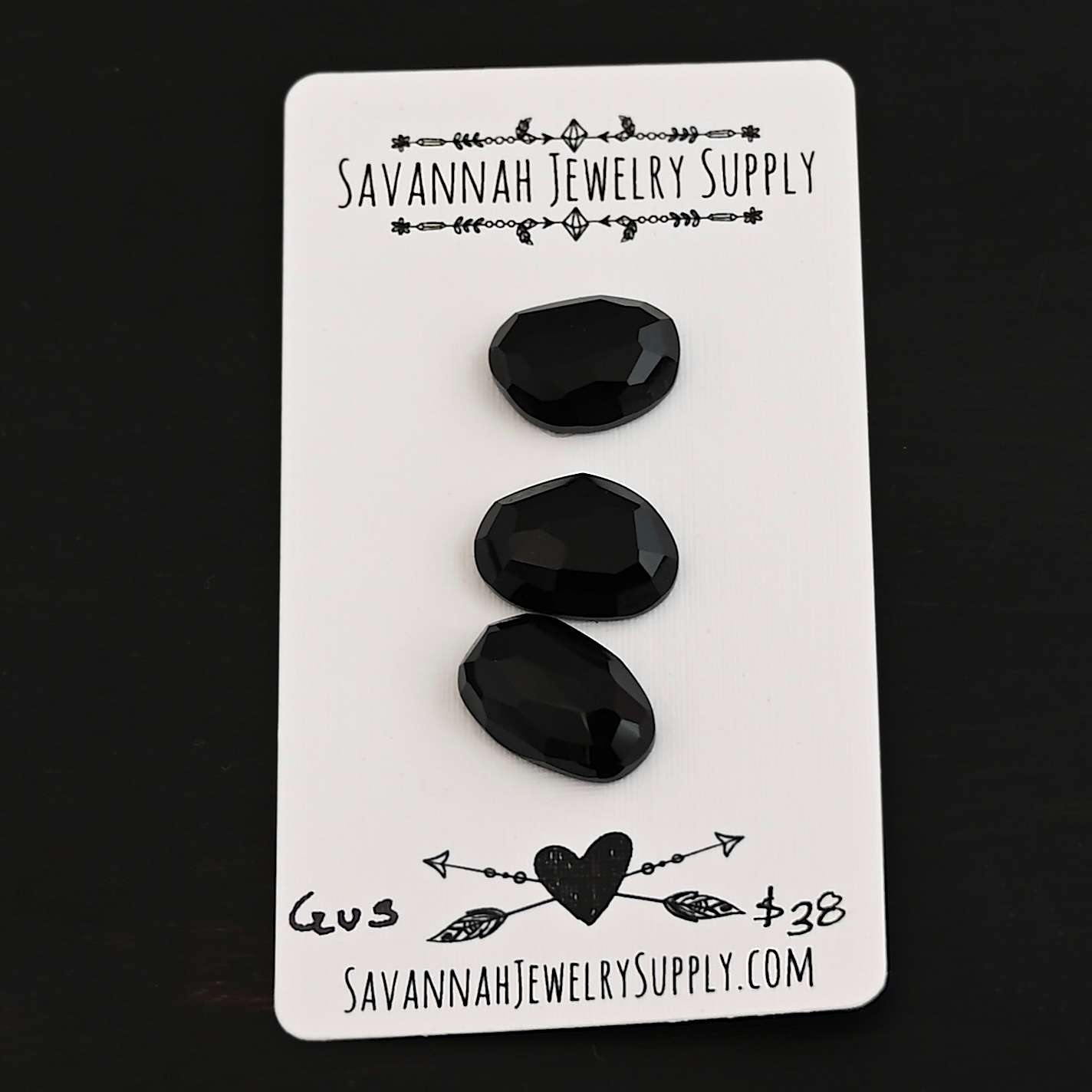 Gus Black Onyx Cabochon Parcel shown on business card