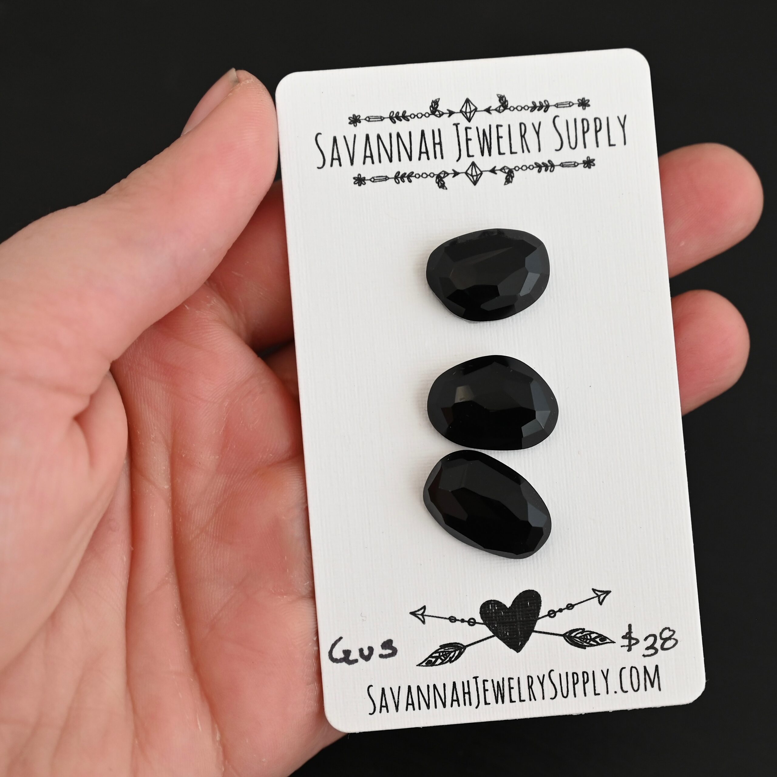 Gus Black Onyx Cabochon Parcel shown in hand