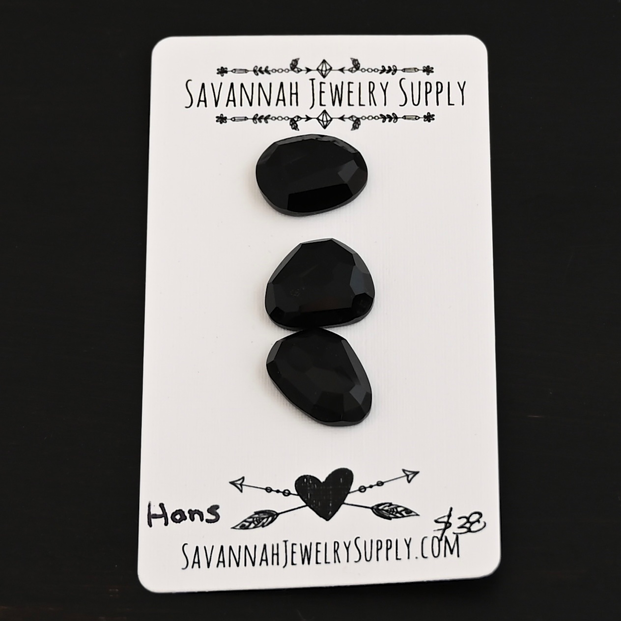 Hans Black Onyx Cabochon Parcel shown on business card