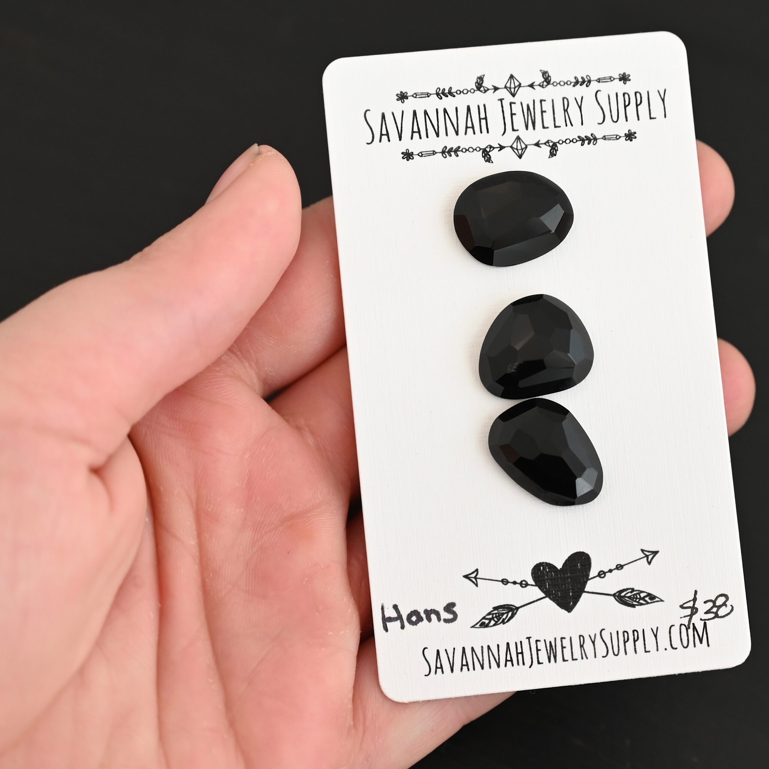 Hans Black Onyx Cabochon Parcel shown in hand