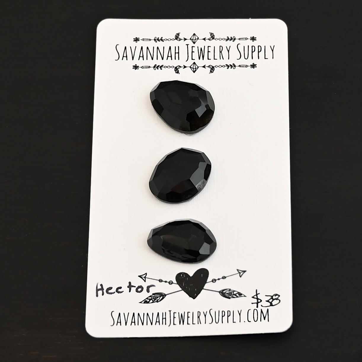 Hector Black Onyx Cabochon Parcel shown on business card