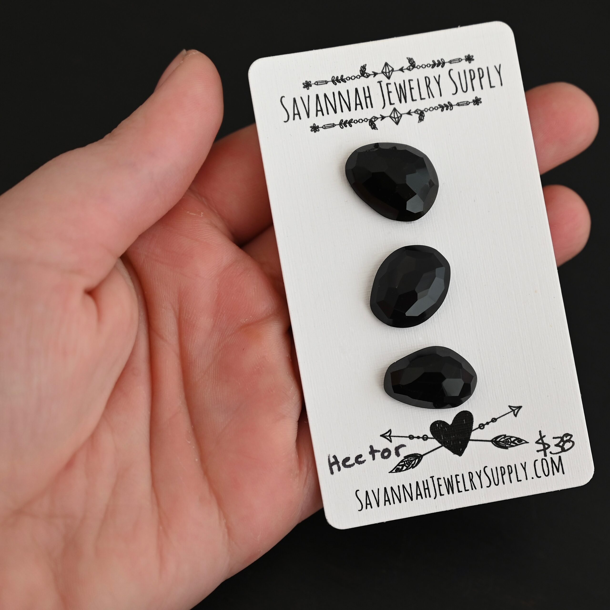 Hector Black Onyx Cabochon Parcel shown in hand