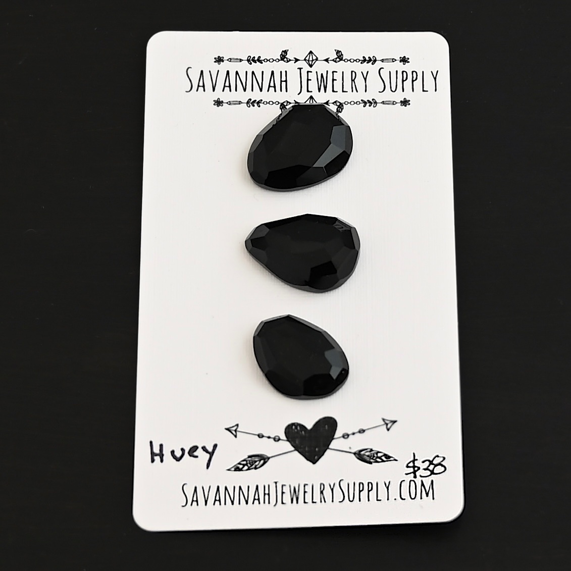Huey Black Onyx Cabochon Parcel shown on business card