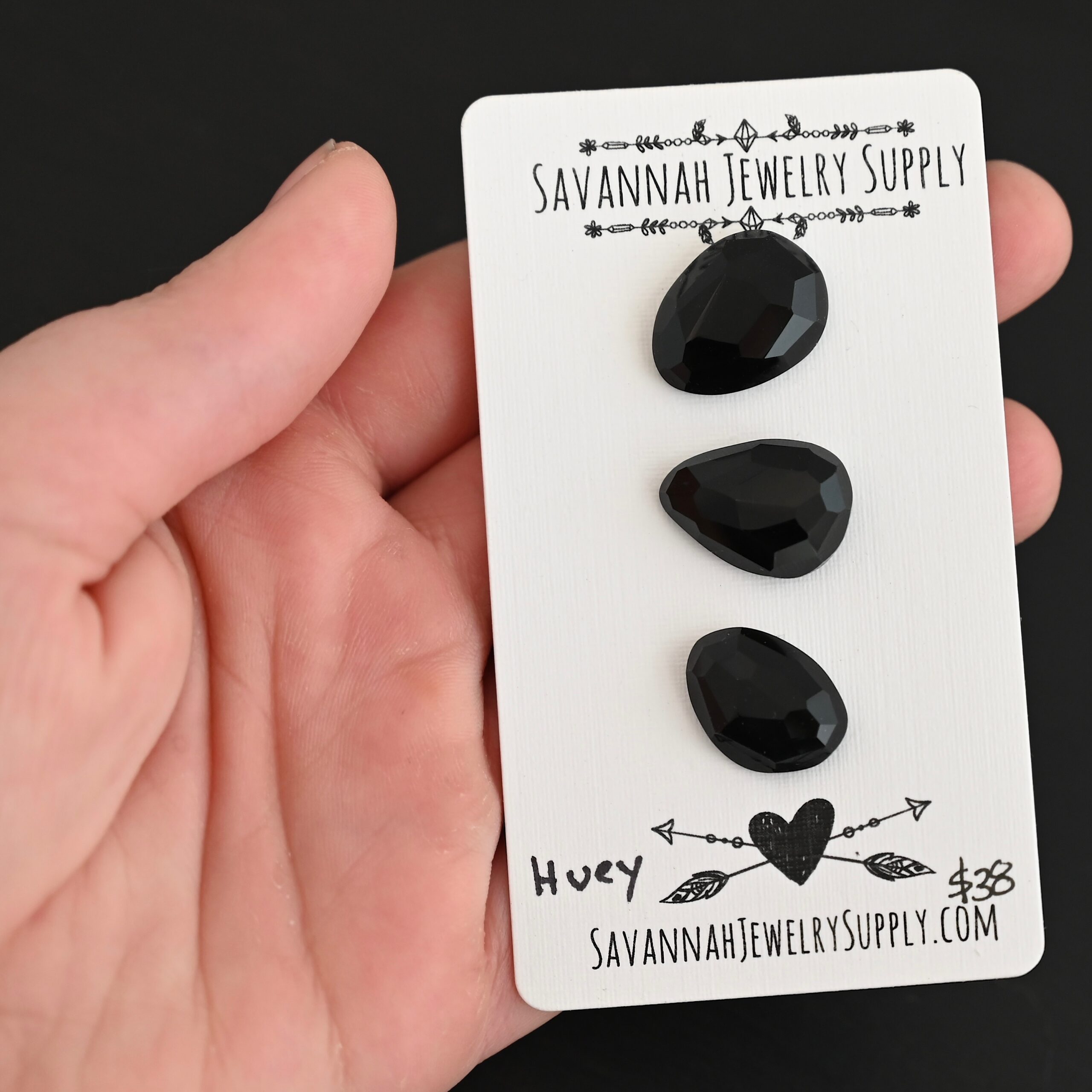 Huey Black Onyx Cabochon Parcel shown in hand