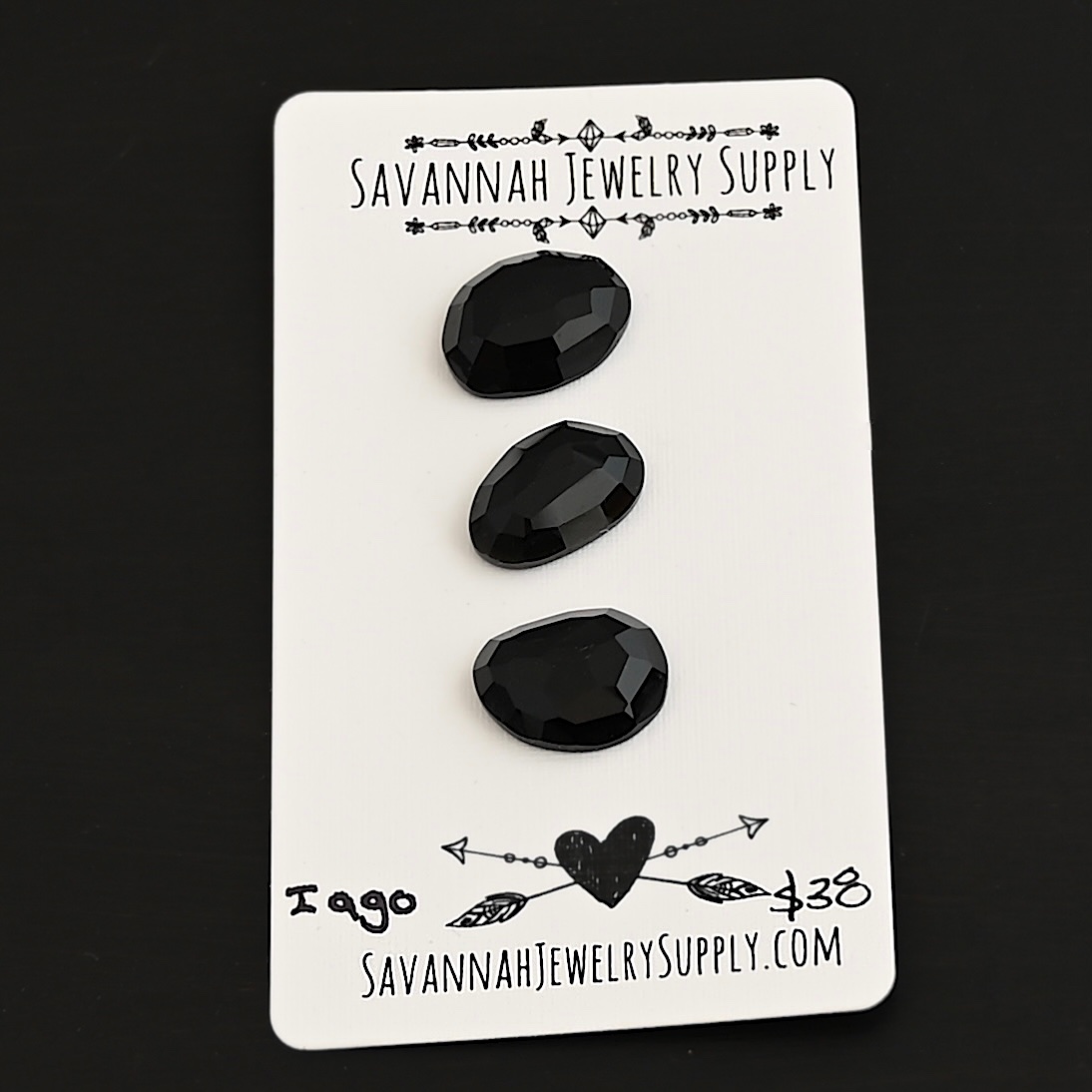 Iago Black Onyx Cabochon Parcel shown on business card