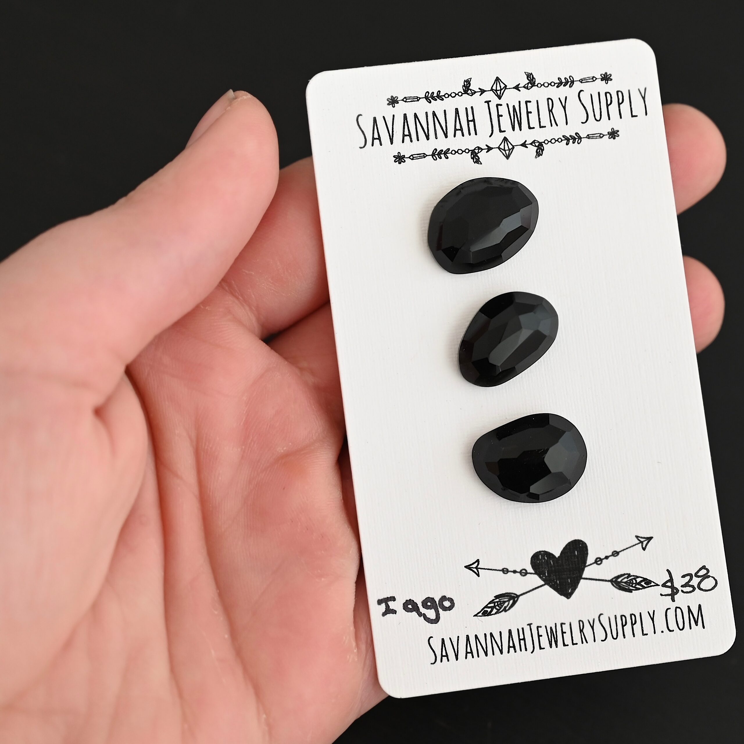 Iago Black Onyx Cabochon Parcel shown in hand