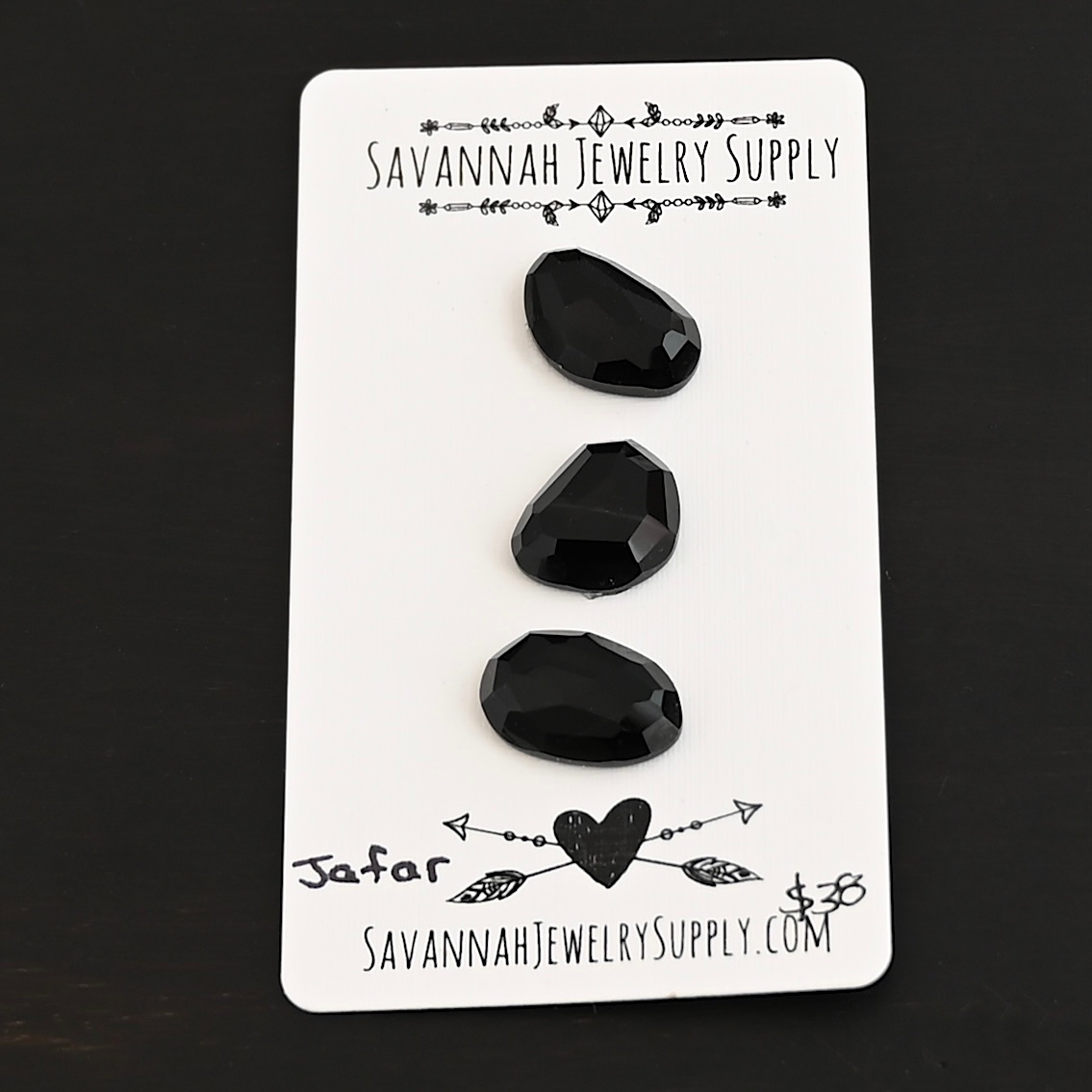 Jafar Black Onyx Cabochon Parcel shown on business card