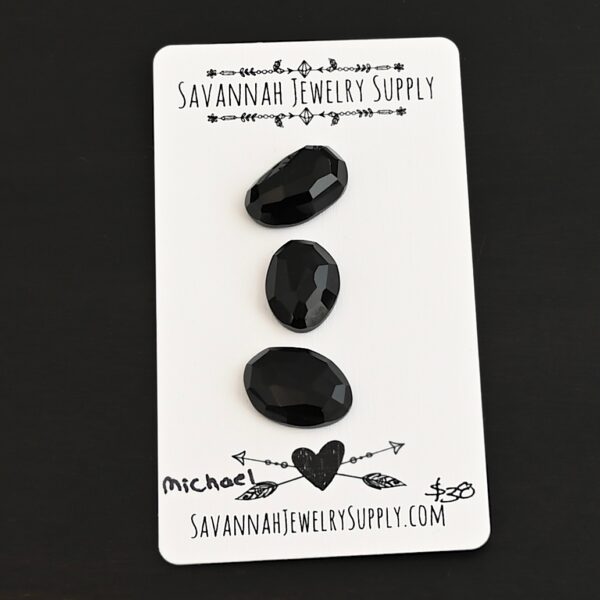 Michael Black Onyx Cabochon Parcel shown on business card