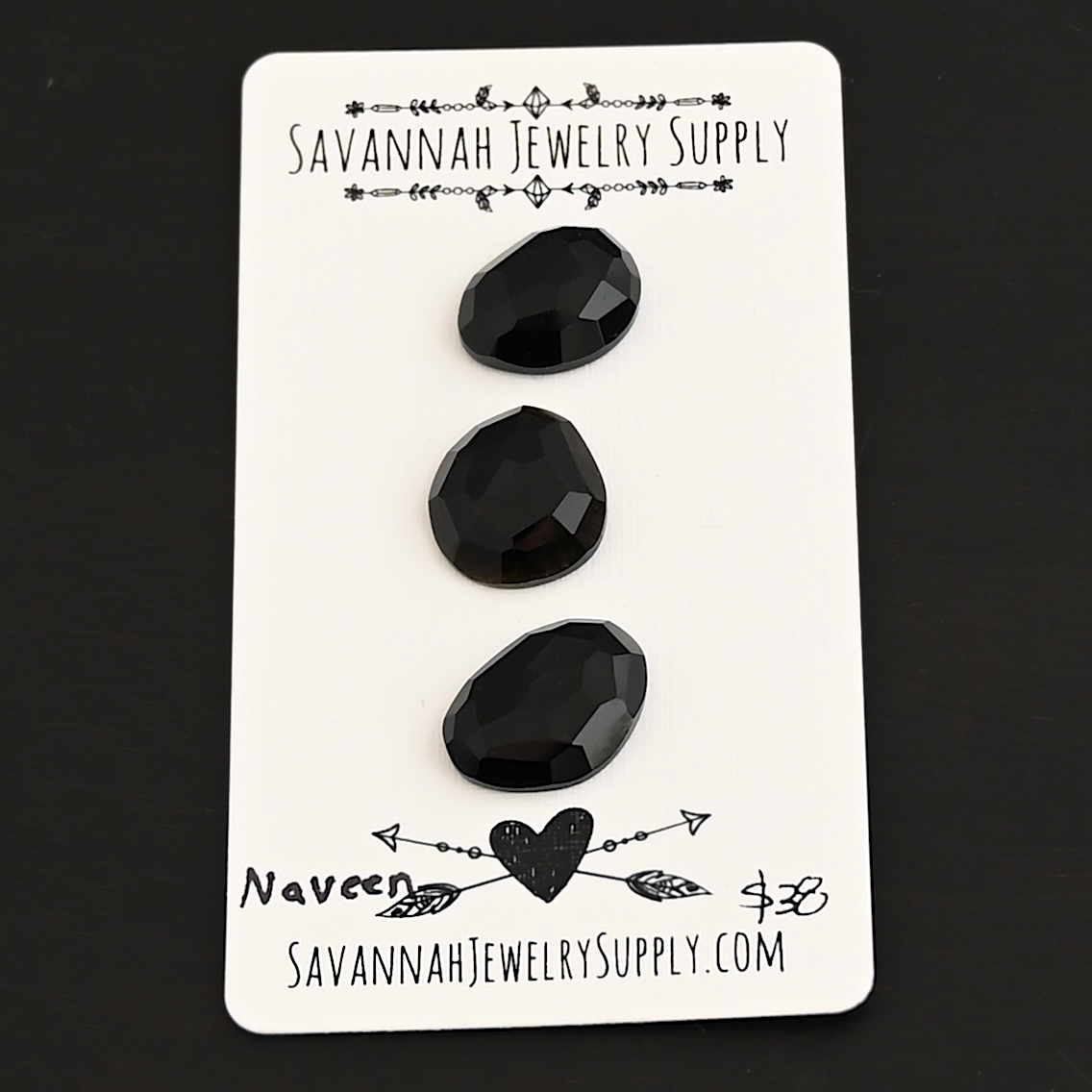 Naveen Black Onyx Cabochon Parcel shown on business card