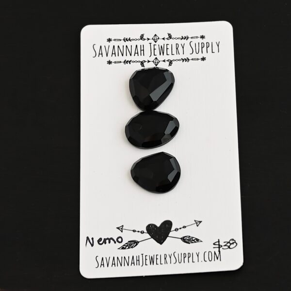 Nemo Black Onyx Cabochon Parcel shown on business card