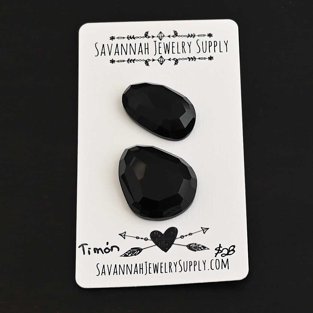 Timon Black Onyx Cabochon Parcel shown on business card
