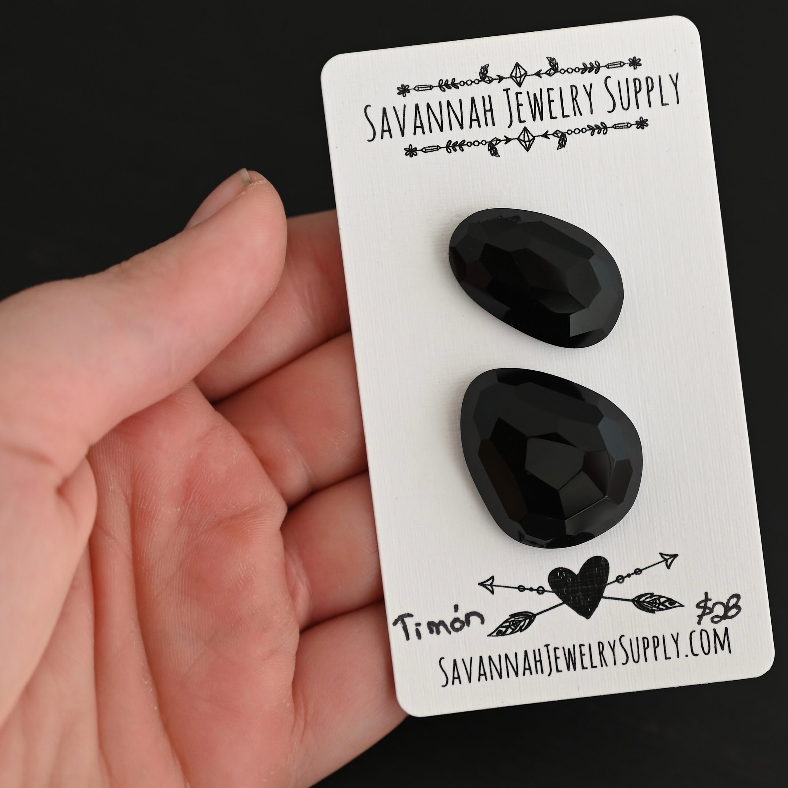 Timon Black Onyx Cabochon Parcel shown in hand