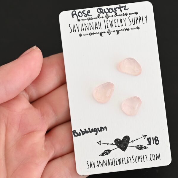 Bubblegum Rose Cut Rose Quartz Cabochon Parcel shown in hand