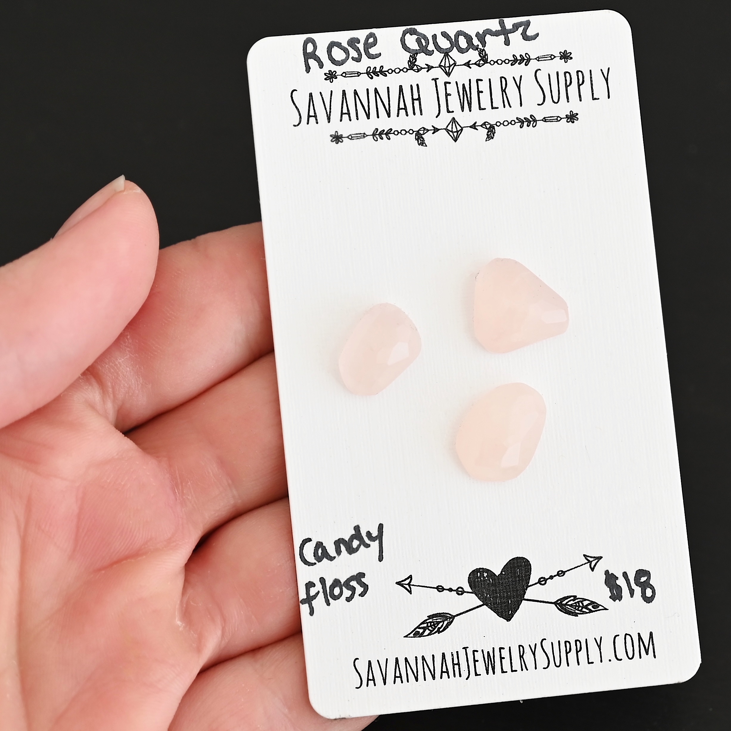 Candy Floss Rose Cut Rose Quartz Cabochon Parcel shown in hand