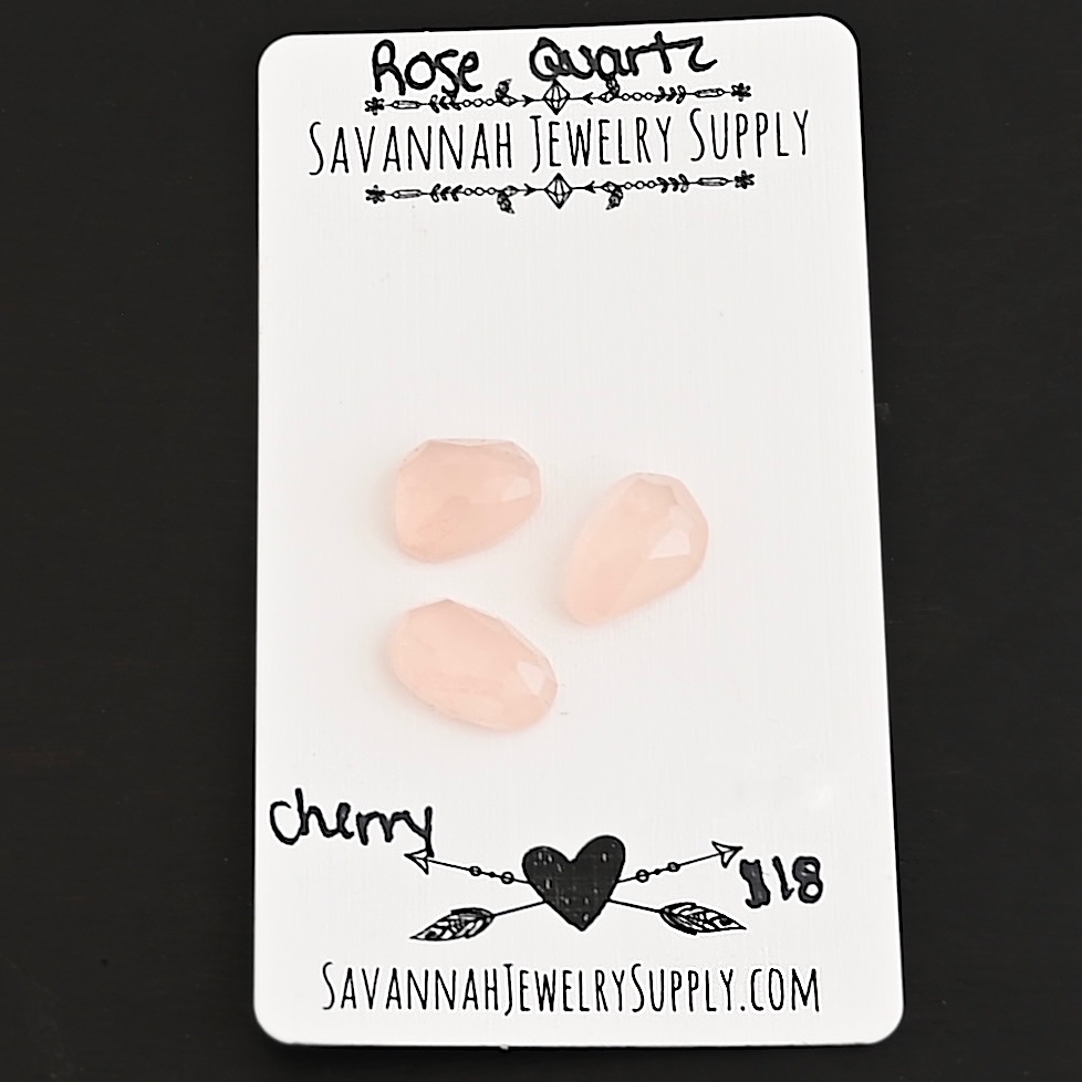 Cherry Rose Cut Rose Quartz Cabochon Parcel shown on business card