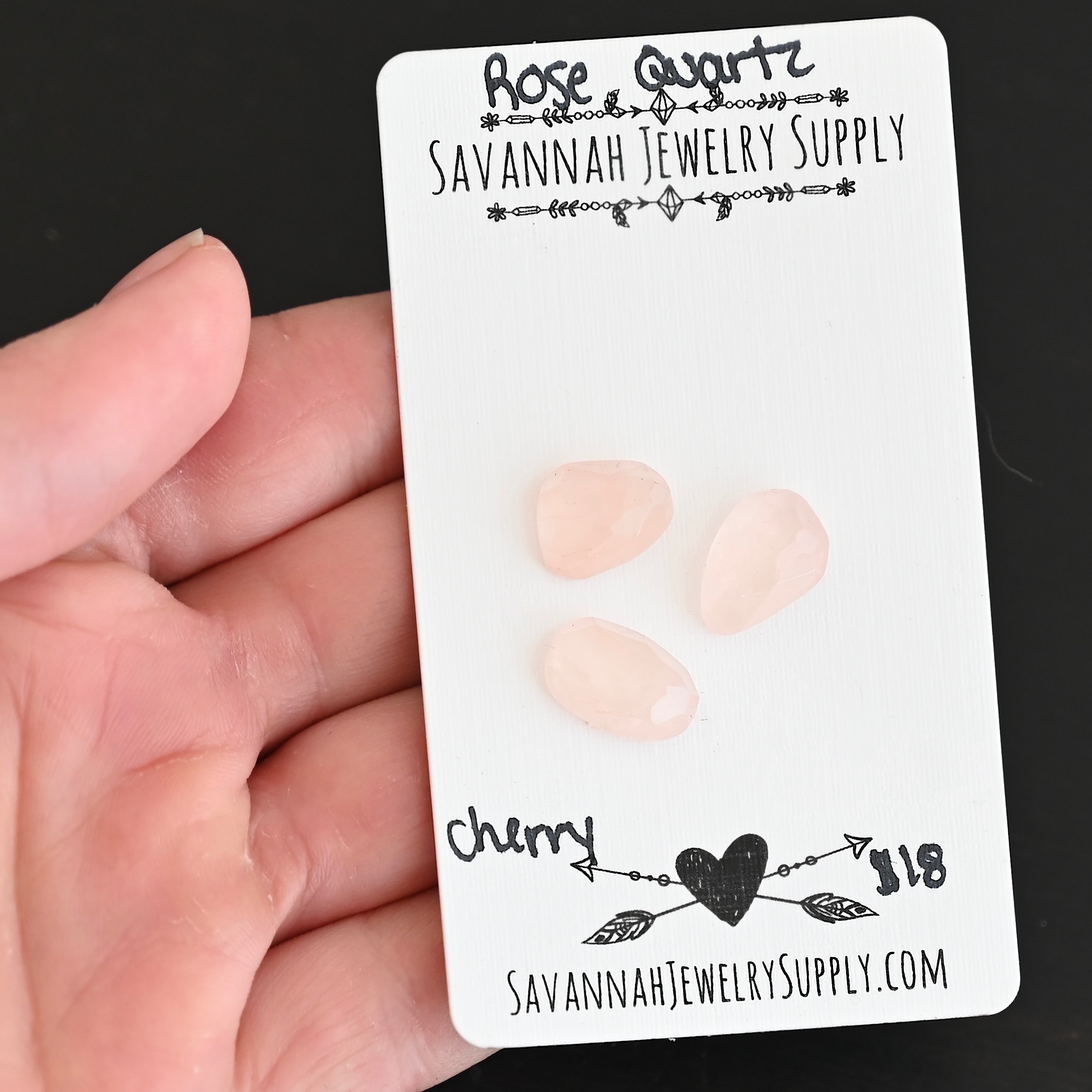 Cherry Rose Cut Rose Quartz Cabochon Parcel shown in hand