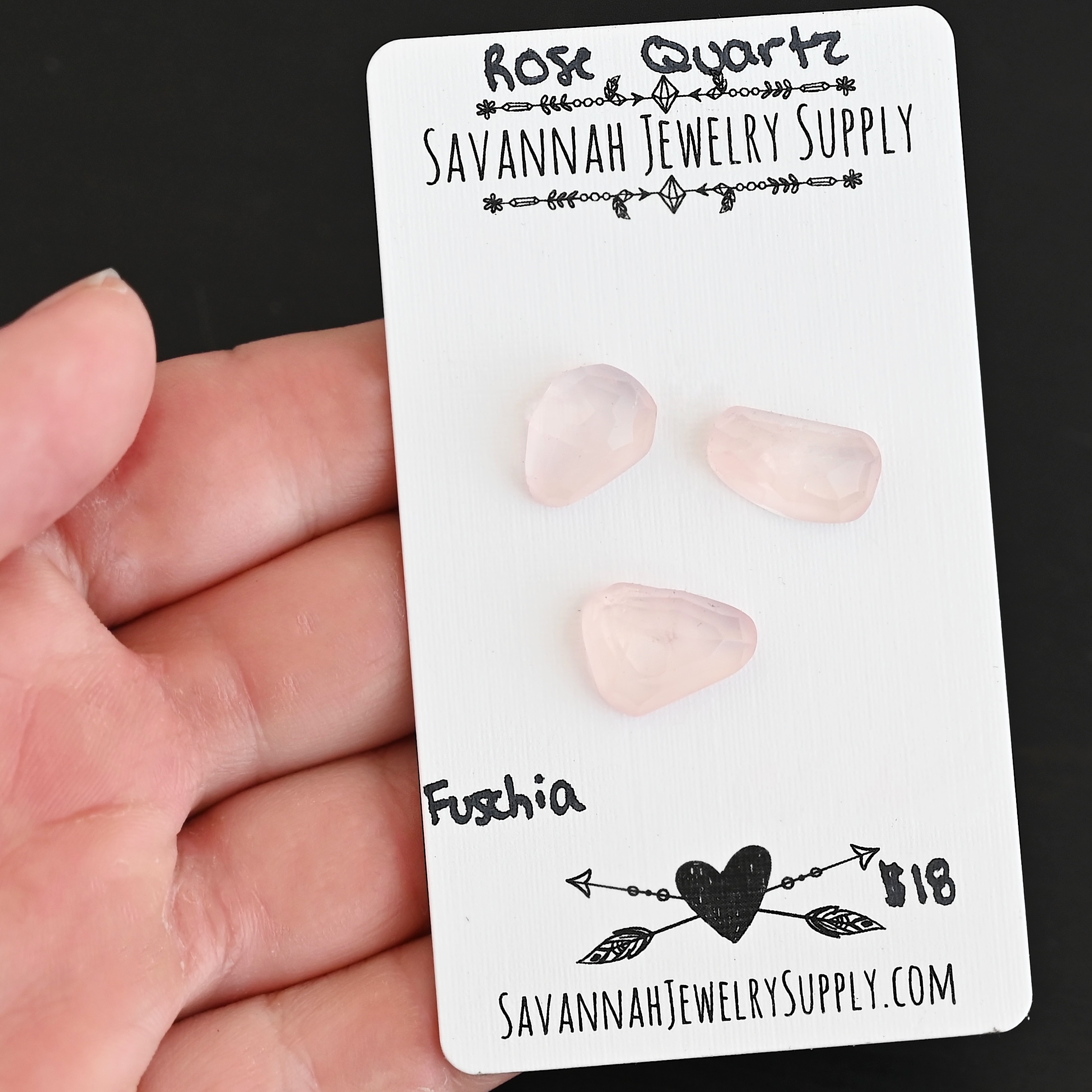Fuchsia Rose Cut Rose Quartz Cabochon Parcel shown in hand