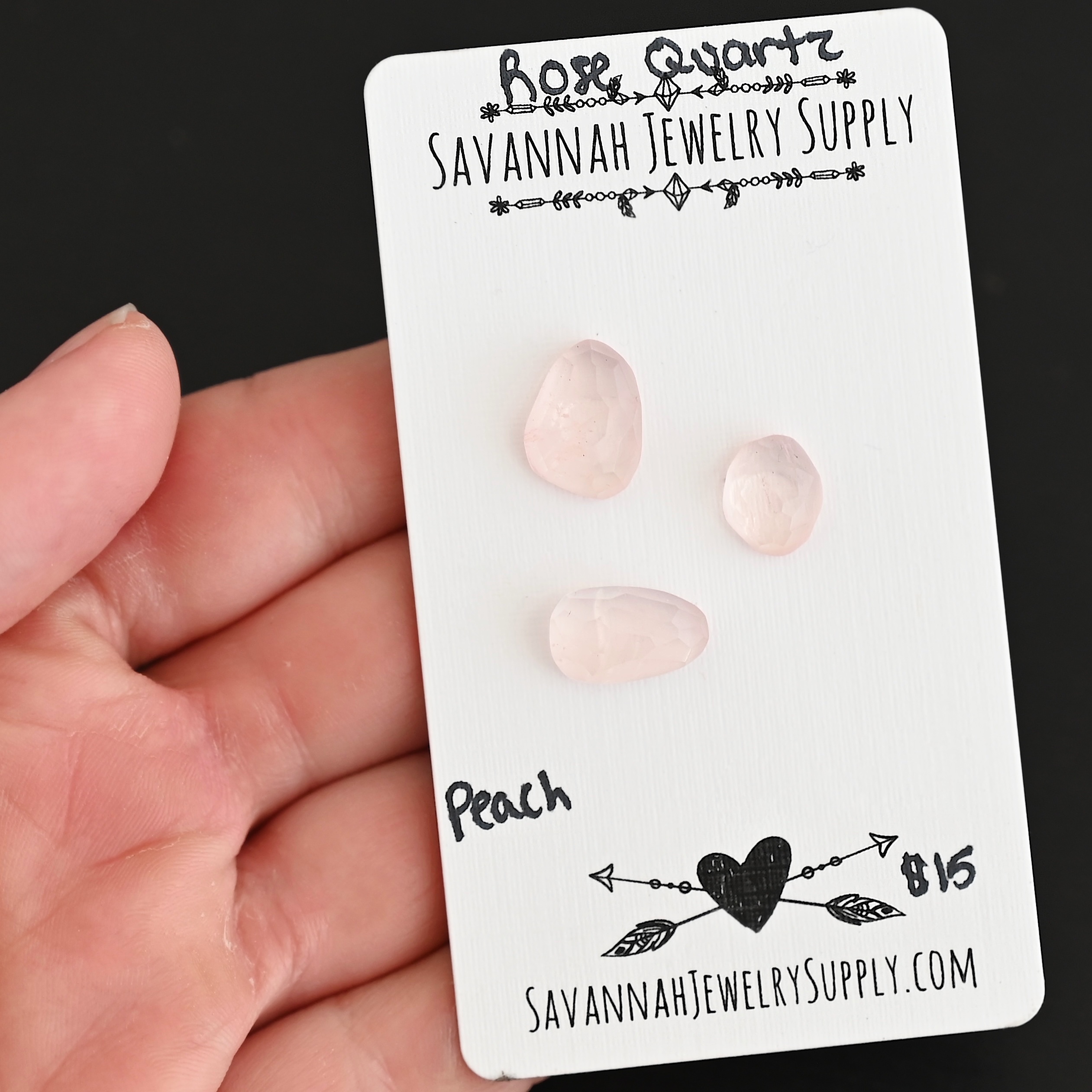 Peach Rose Cut Rose Quartz Cabochon Parcel shown in hand