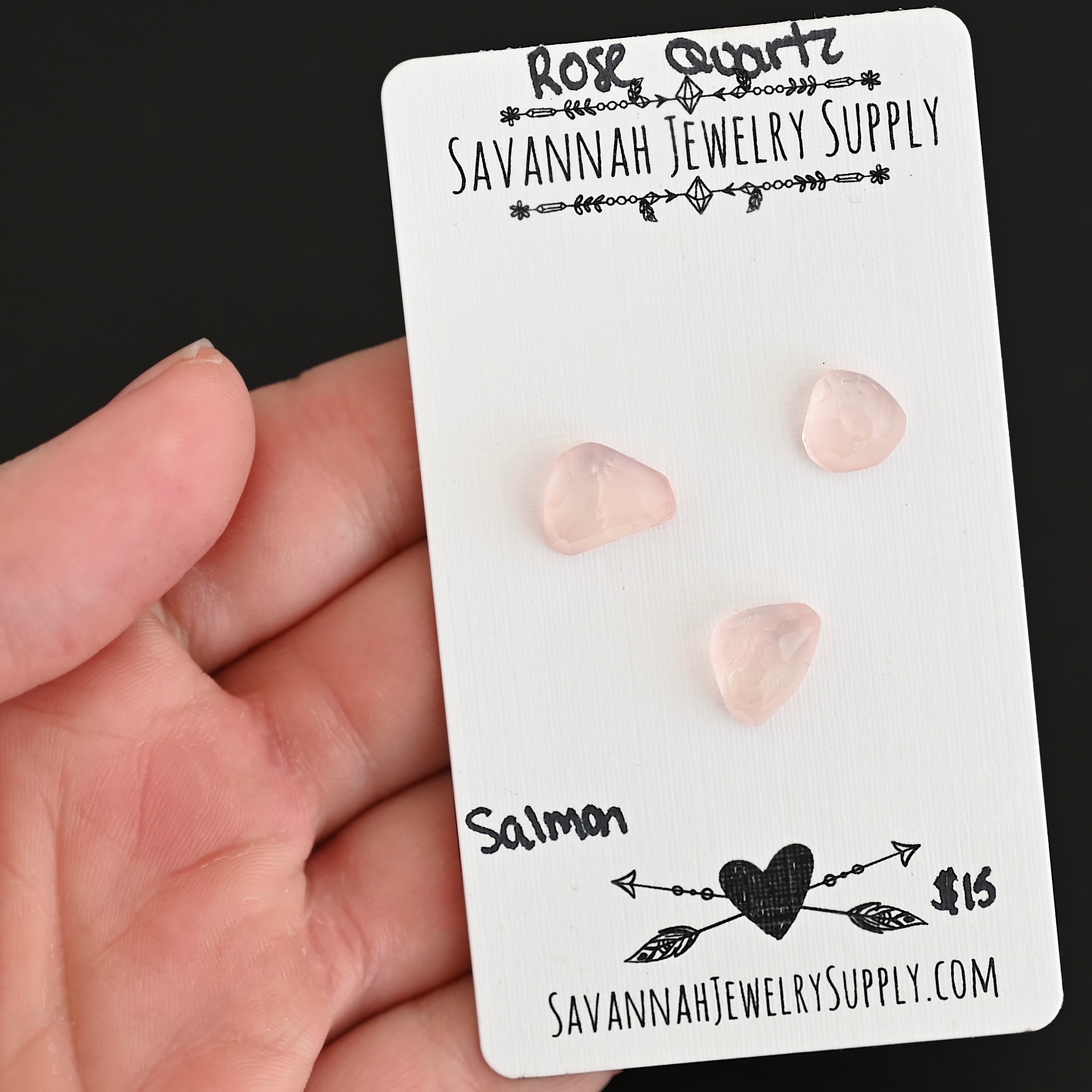 Salmon Rose Cut Rose Quartz Cabochon Parcel shown in hand