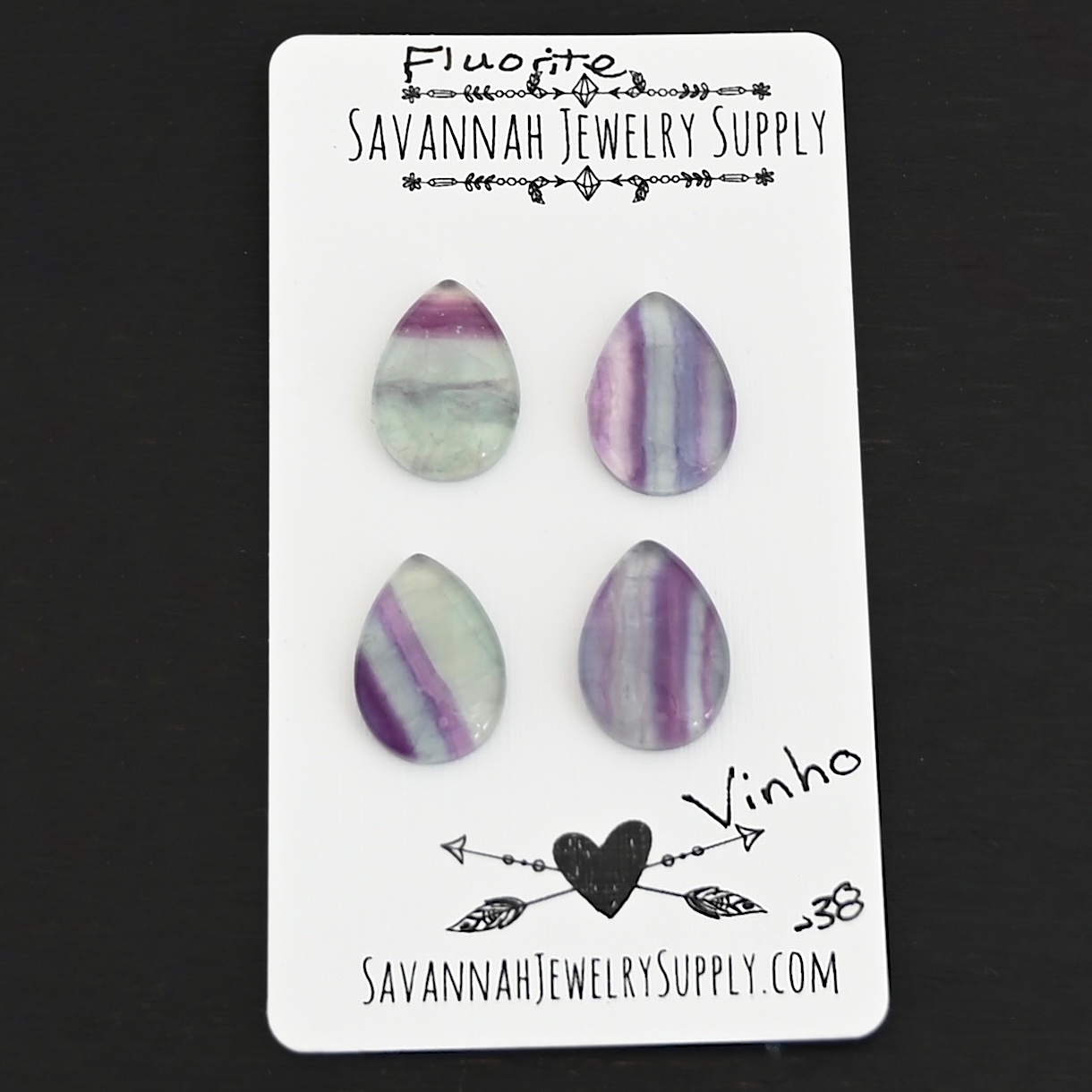 Vinho Fluorite Cabochon Parcel shown on business card