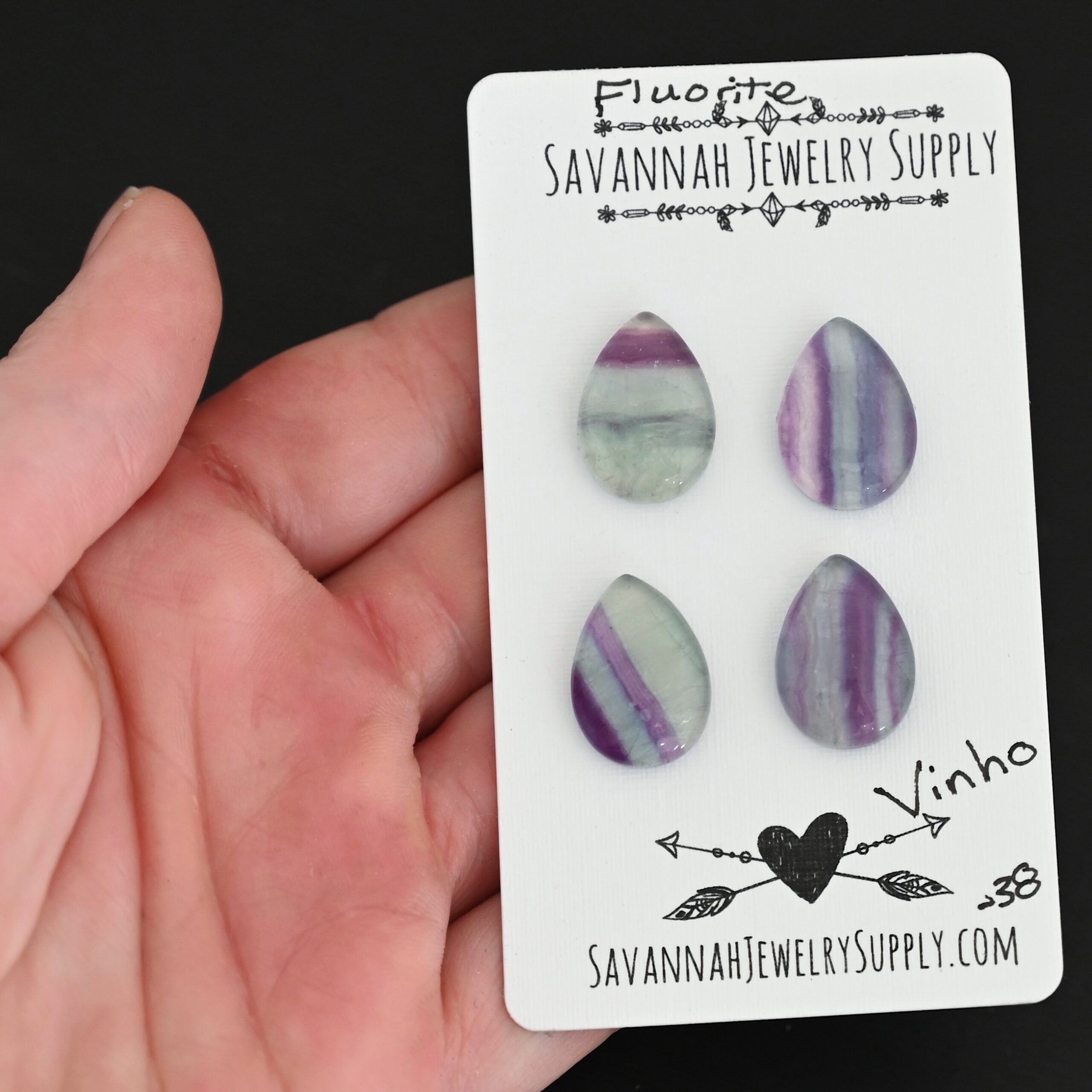 Vinho Fluorite Cabochon Parcel shown in hand