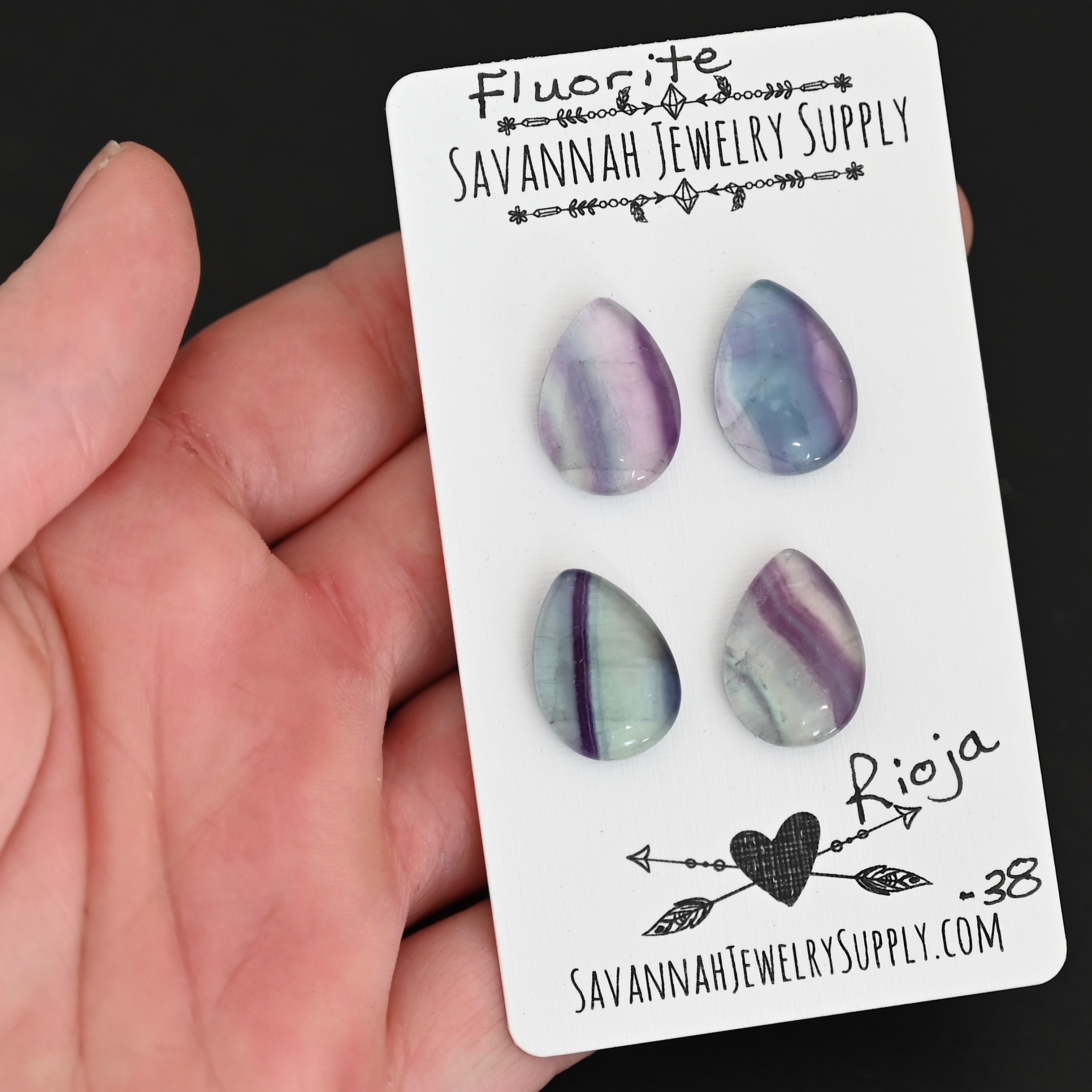 Rioja Fluorite Cabochon Parcel shown in hand