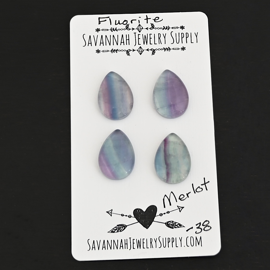 Merlot Fluorite Cabochon Parcel shown on business card