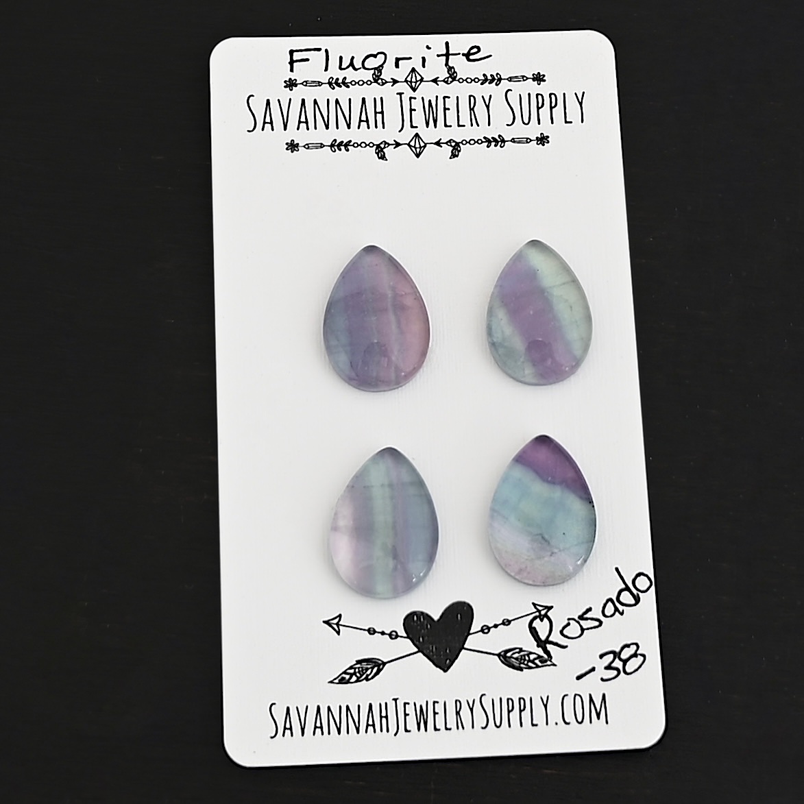 Rosado Fluorite Cabochon Parcel shown on business card