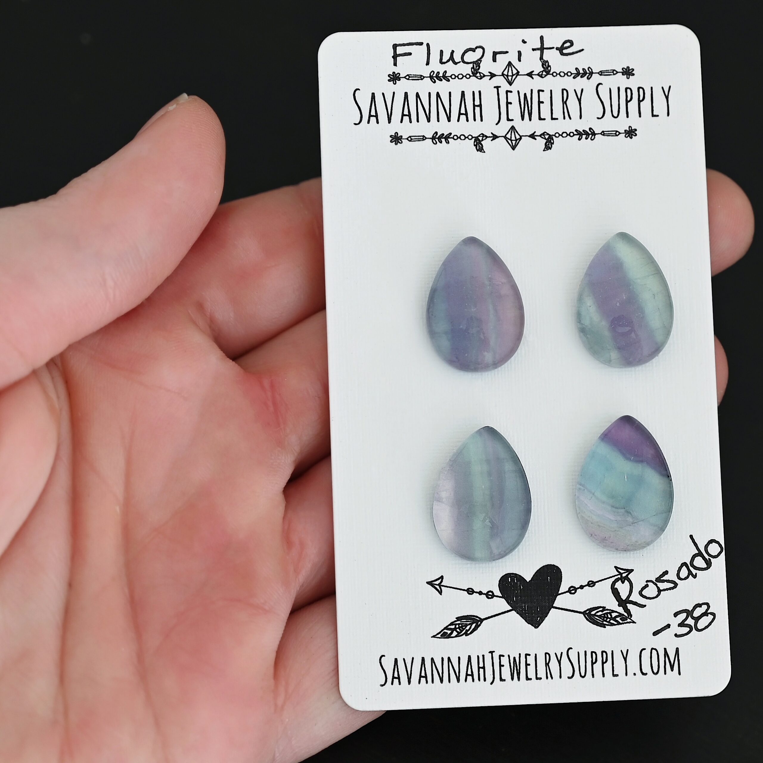 Rosado Fluorite Cabochon Parcel shown in hand