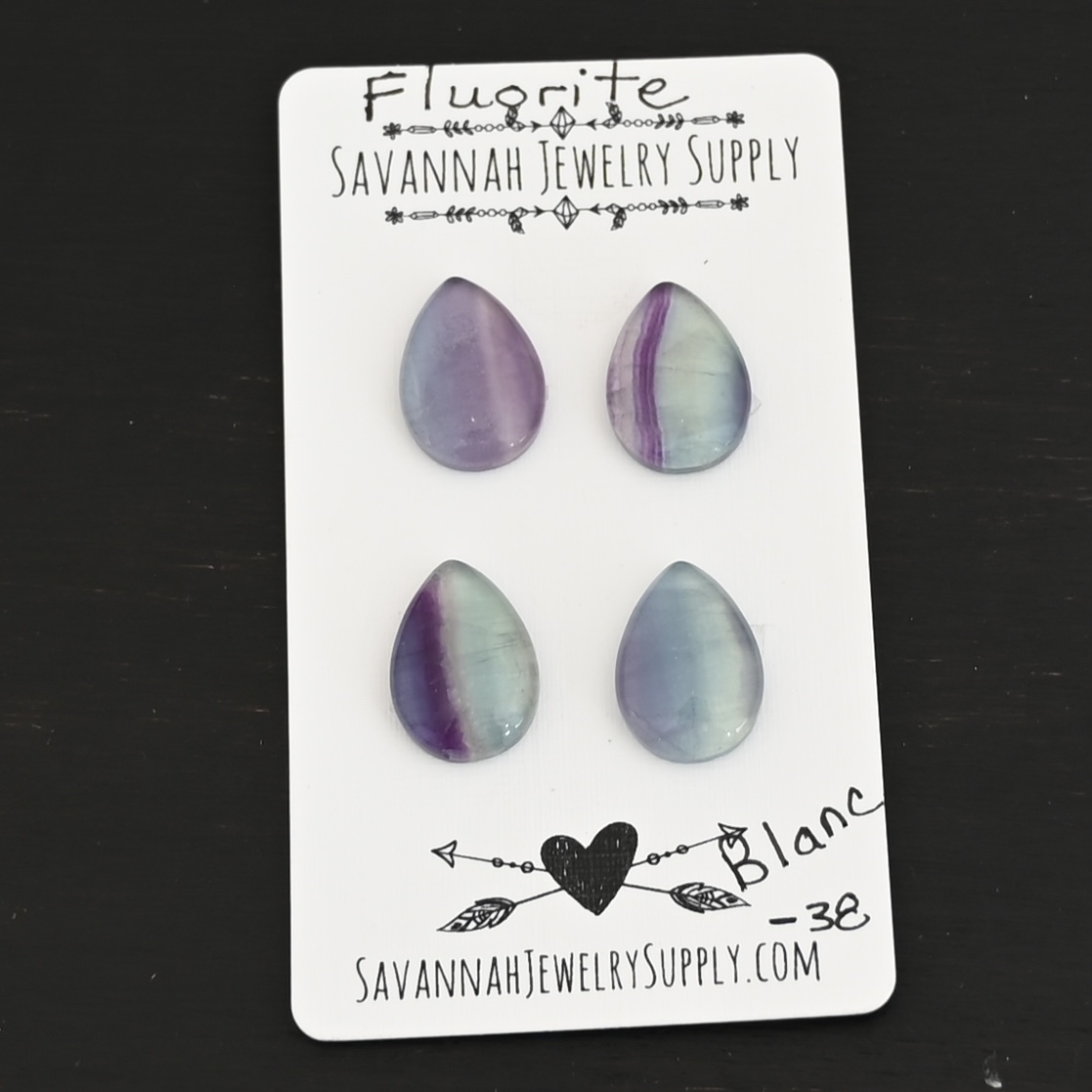 Blanc Fluorite Cabochon Parcel shown on business card