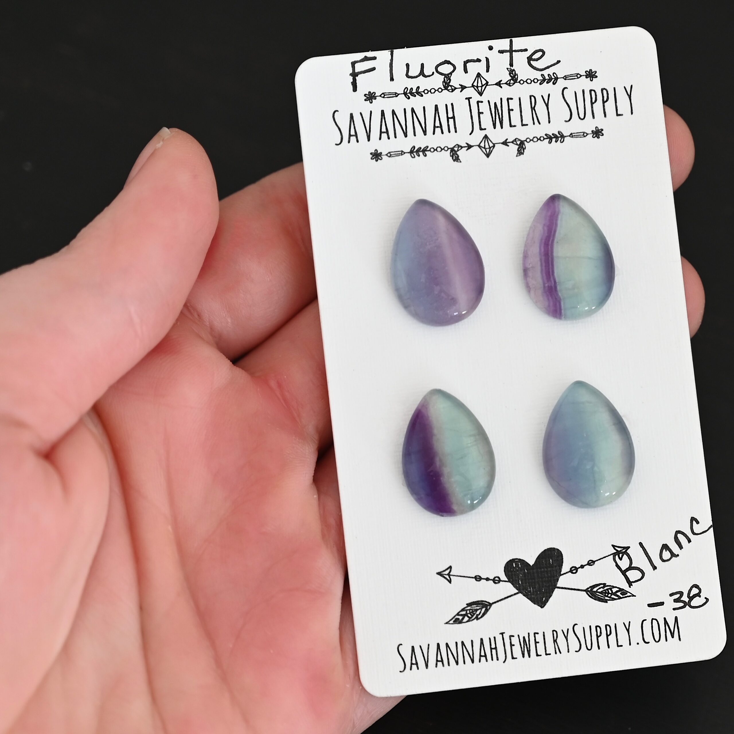 Blanc Fluorite Cabochon Parcel shown in hand