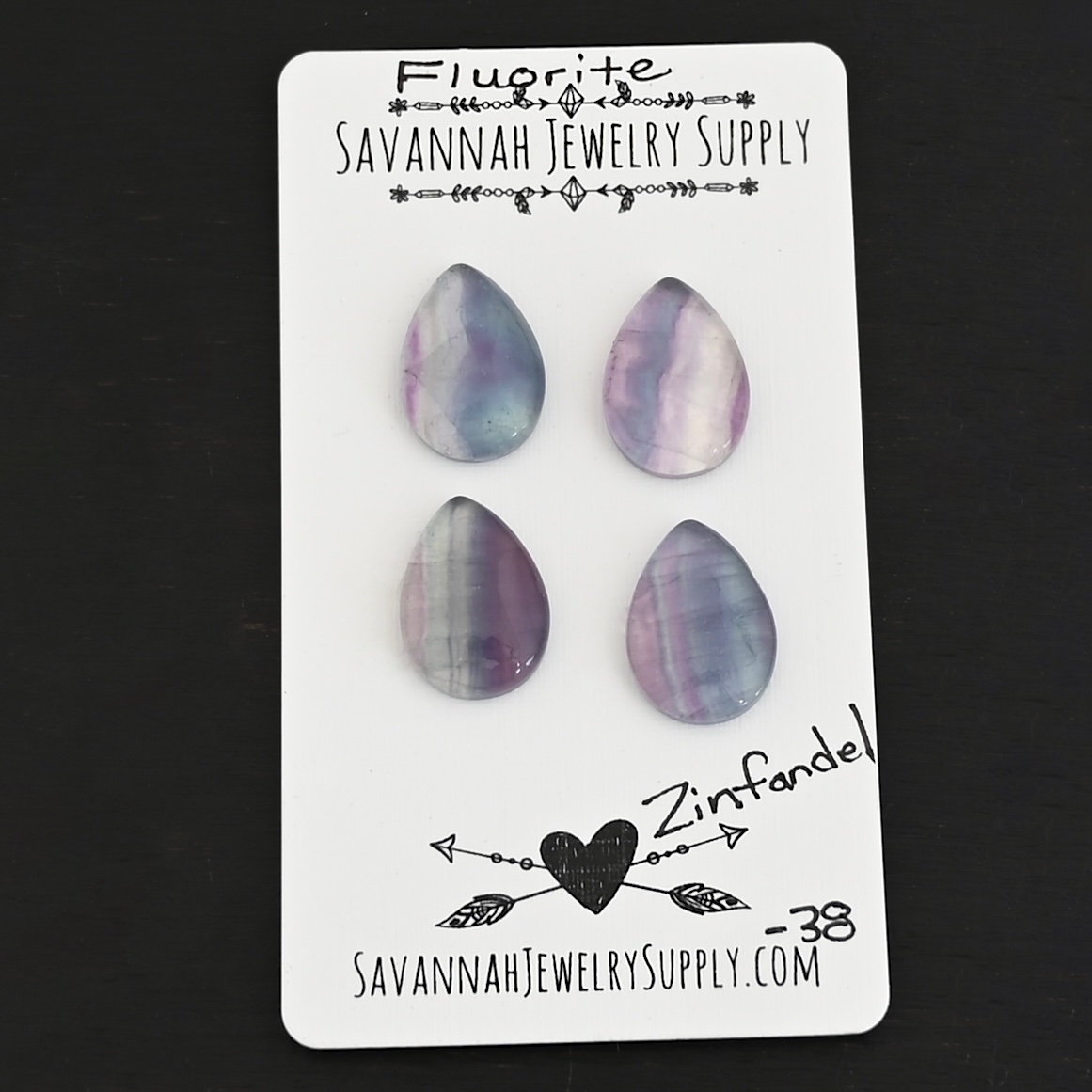 Zinfandel Fluorite Cabochon Parcel shown on business card