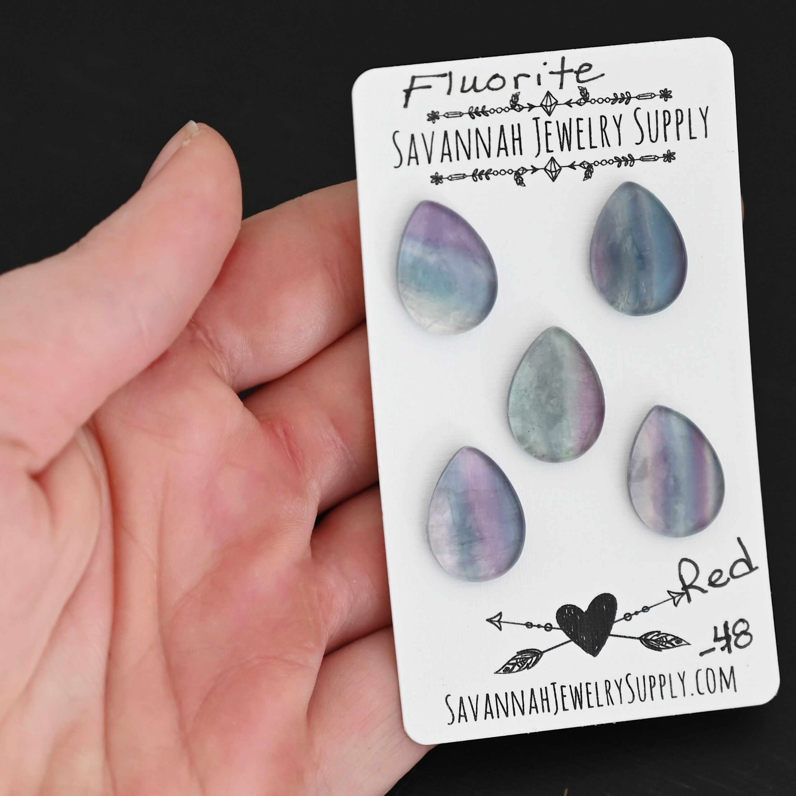 Red Fluorite Cabochon Parcel shown in hand